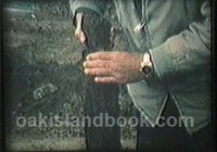 Robert Dunfield holding notched wood artifact